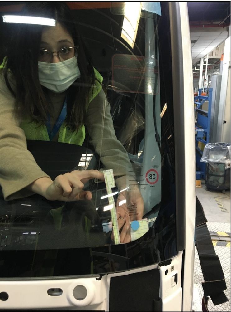 Working inside a truck cab at the windscreen sensor area.